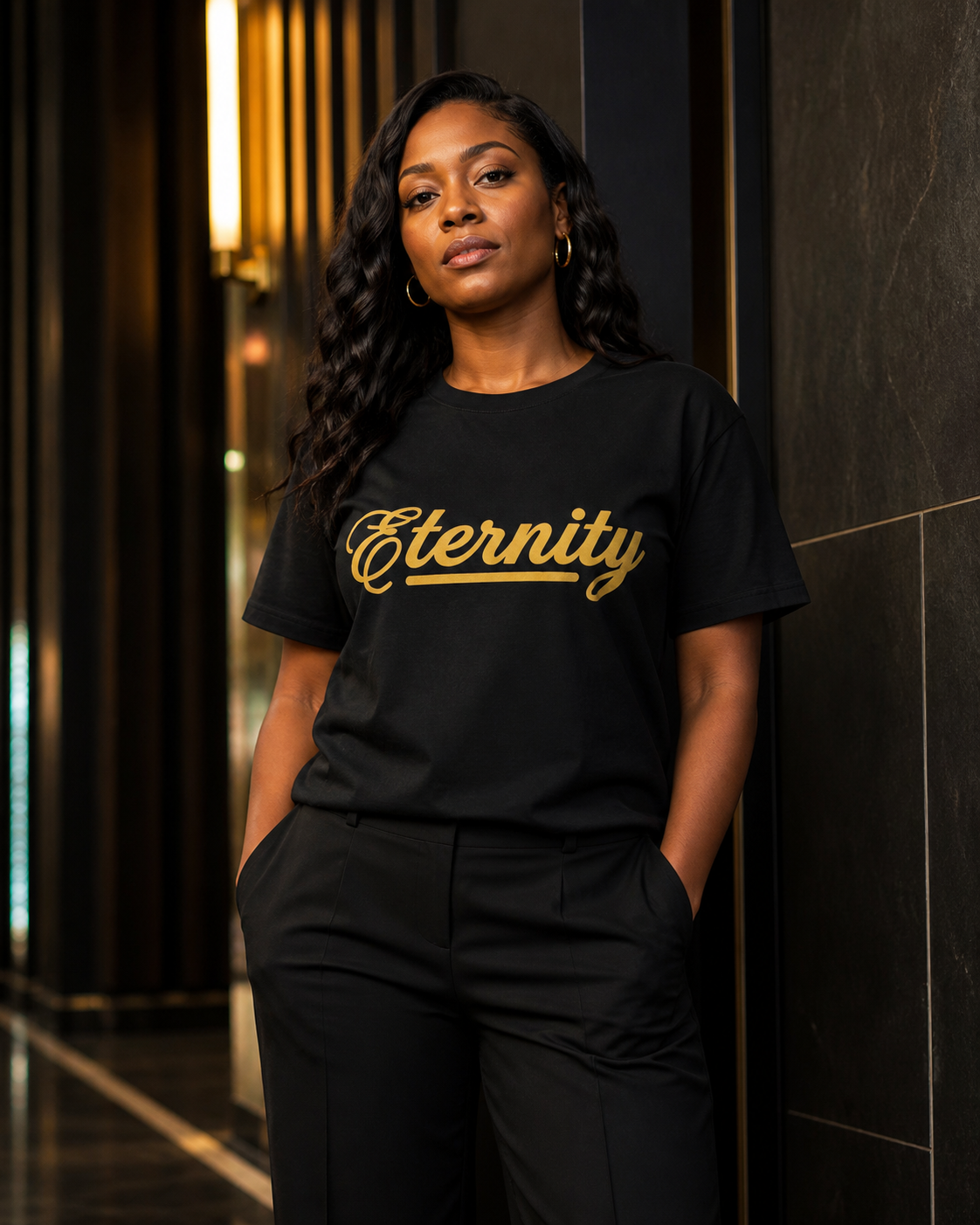Woman modeling the black and gold Eternity heavyweight tee