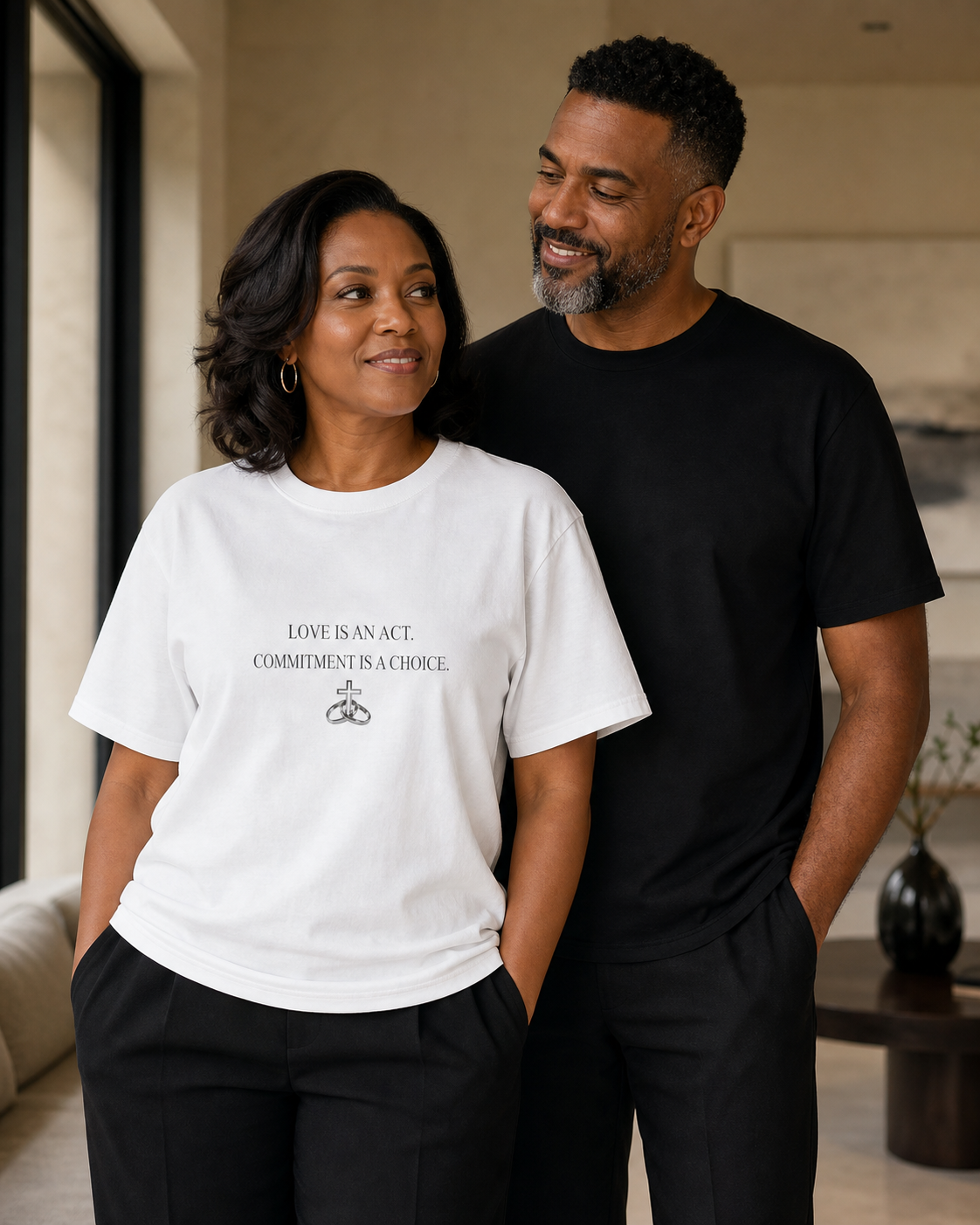 Couple modeling the Love Is an Act heavyweight tee